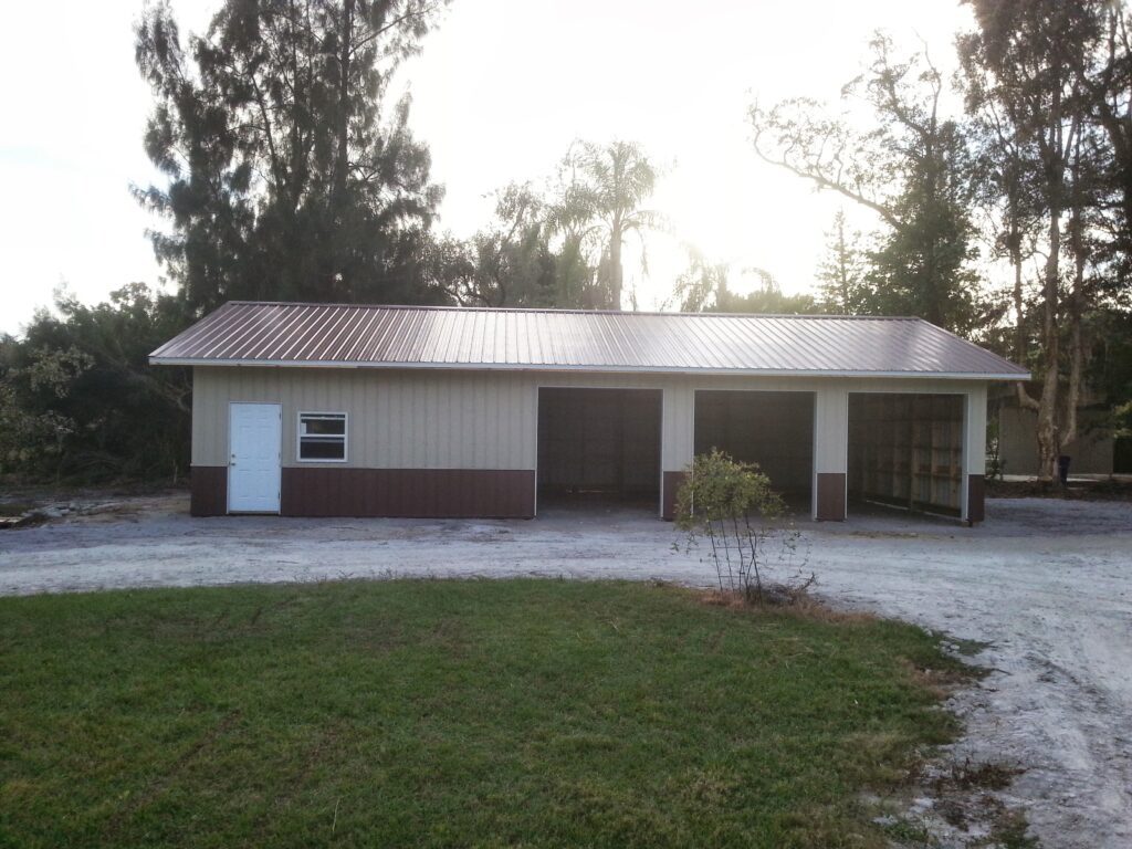 Finished post frame shop building with garage bays built by Buildings By Bill in Florida